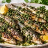 Grilled sardines with parsley-cilantro chermoula and lemon wedges