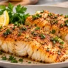 Golden air-fried pollock fillets seasoned with paprika and parsley, plated with fresh lemon wedges