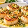 Golden pan-seared sea scallops served with garlic lemon butter and parsley